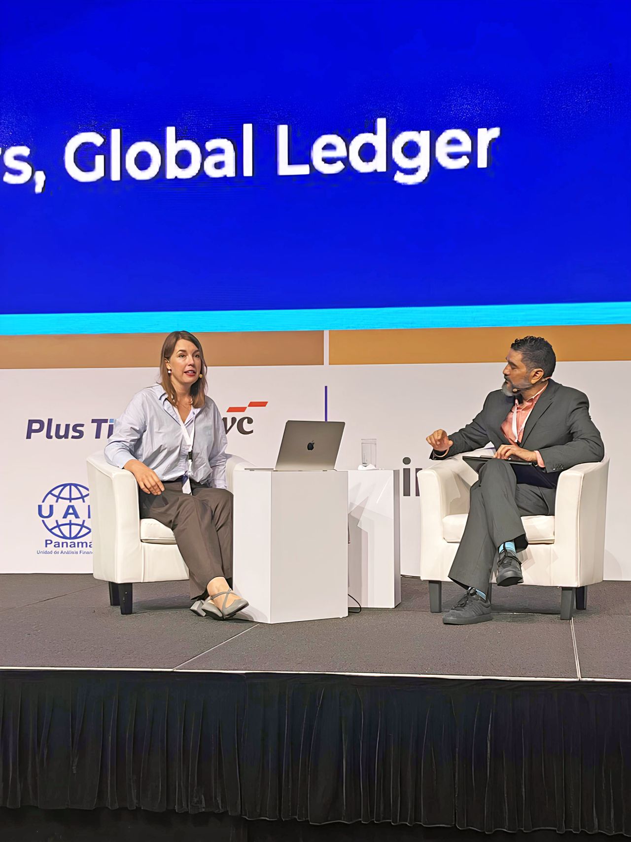 Yulia Murat, Head of Regulatory Affairs at Global Ledger (pictured on the left), speaking during the panel discussion at the conference